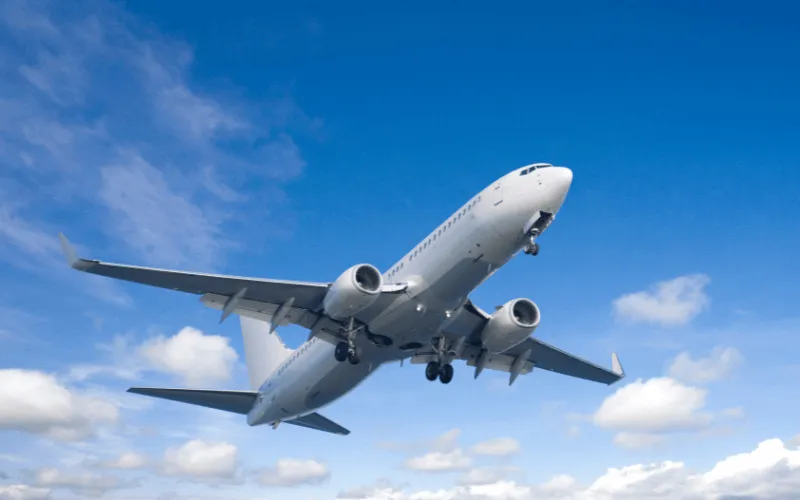 Commercial airplane flying in clear blue sky during daytime