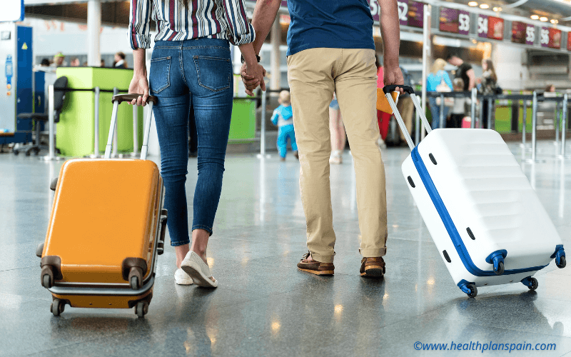 Airport passengers pulling suitcases