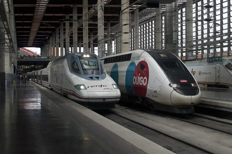 High-speed Renfe AVE and Ouigo trains at platform inside Madrid train station