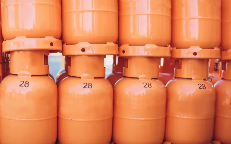 Stacked orange butane gas bottles commonly used in Spanish households