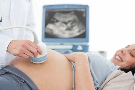 Pregnant woman having an ultrasound scan during prenatal checkup