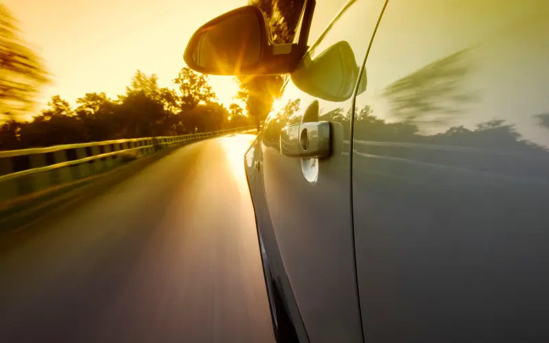 Car driving in sunshine