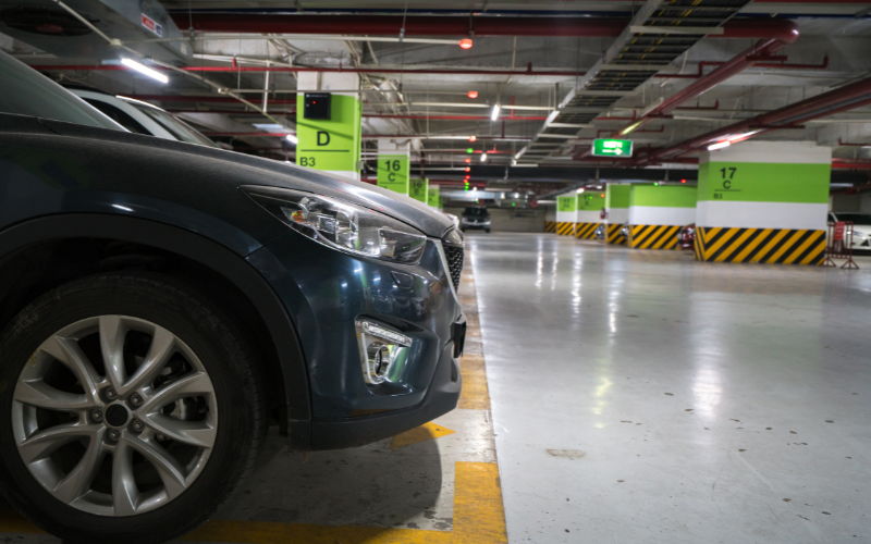 Parked car in underground car park in Spain with section signs and lighting visible