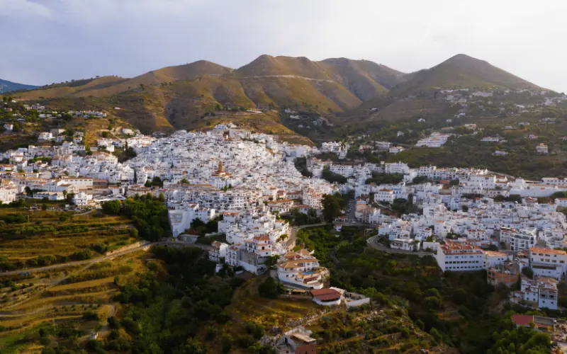 Whitewashed houses in Competa village in Malaga, Spain surrounded by mountains