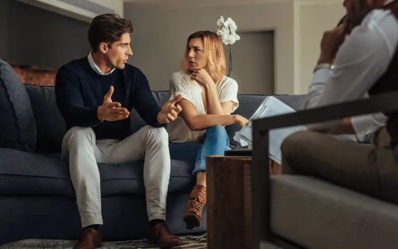 Couple in therapy session discussing relationship issues with counsellor