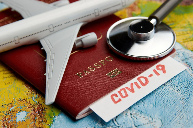Passport with covid label, map and stethoscope
