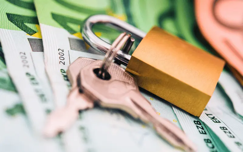 House rental deposit with padlock and keys on euro banknotes