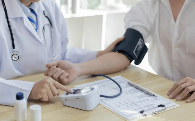 Doctor checking patient’s blood pressure during routine health checkup