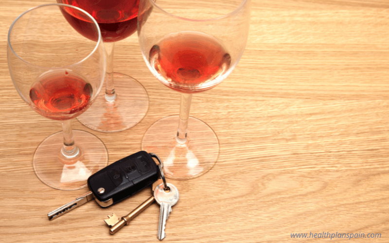 Empty wine glasses with car keys