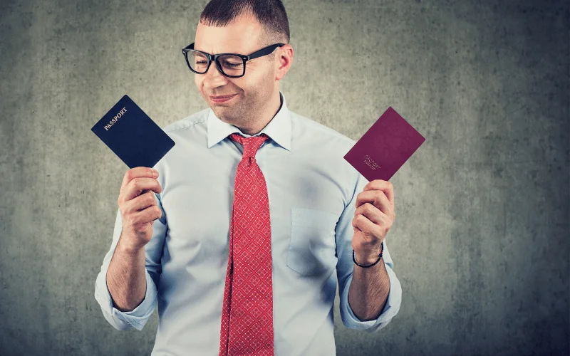 Man holding two passports representing dual citizenship and international identity