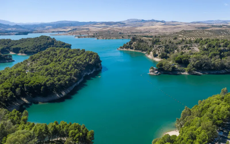 Aerial view of El Chorro reservoir in Malaga surrounded by mountains and forests