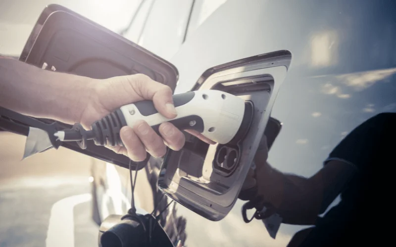 Close-up of electric car being charged with EV connector plug