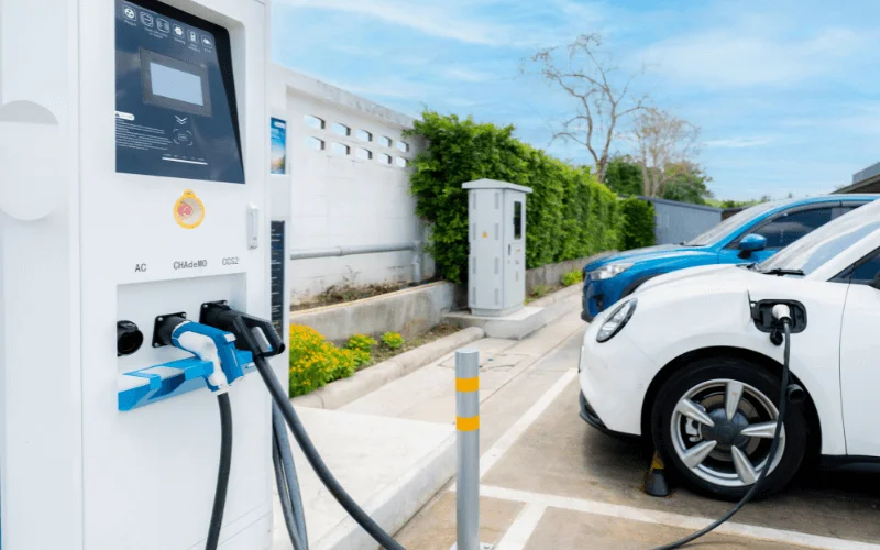 electric vehicle charging at modern station in sunny weather