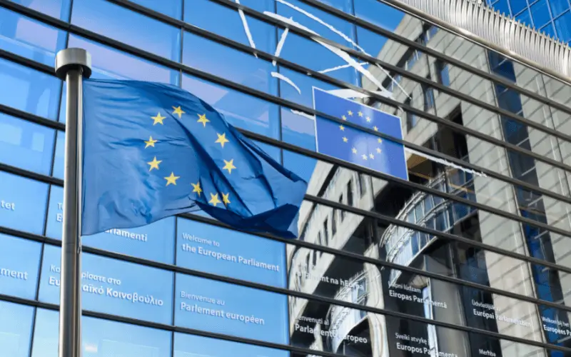 European Parliament building with EU flag in the foreground