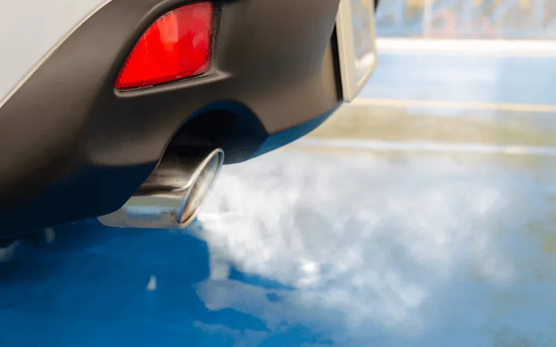 Car exhaust emitting fumes during emissions test