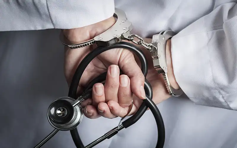 doctor in handcuffs