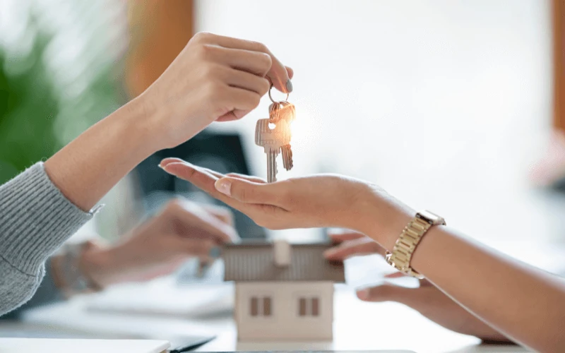 real estate agent handing over house keys to new homeowner in Spain