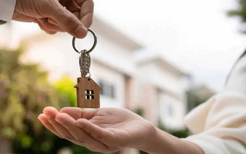 Landlord handing over house key to tenant at rental property in Spain