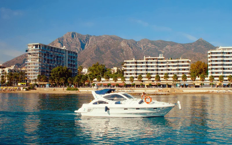 Scenic view of Marbella coastline with mountains and yacht on the sea