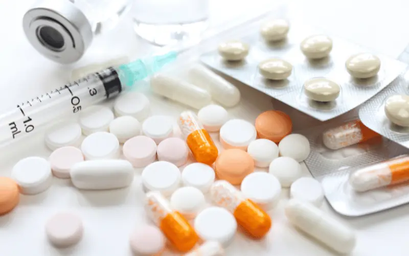 Various prescription medications and syringe highlighting drug safety issues in Spain