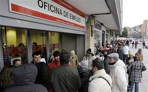 People queue outside a Spanish employment office during a period of high unemployment