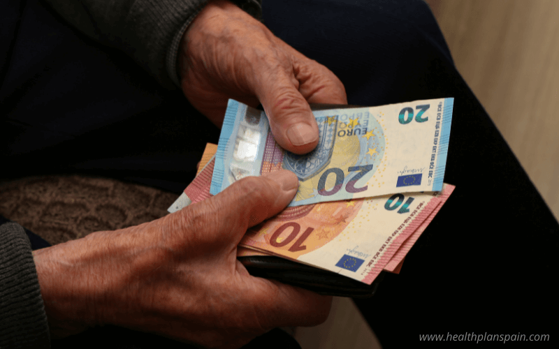 Pensioner holding euro notes