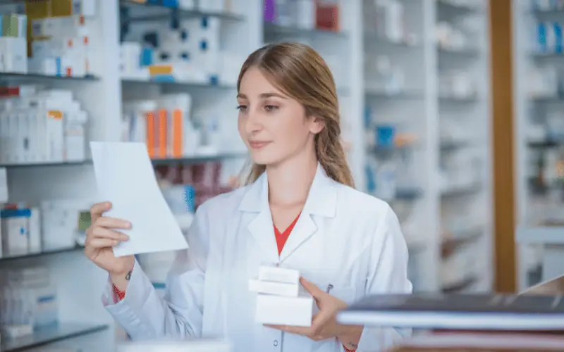 Pharmacist reviewing prescription in a pharmacy store
