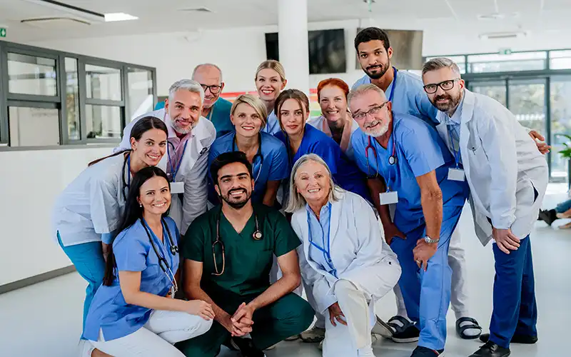 Doctors and nurses in a photo pose