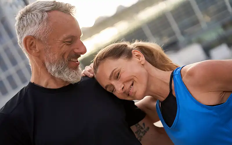middle aged couple resting during jog