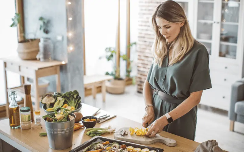 Woman preparing healthy homemade meal with fresh vegetables in modern kitchen