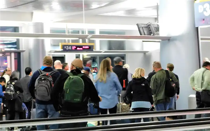 passengers queueing at Spanish airport checks