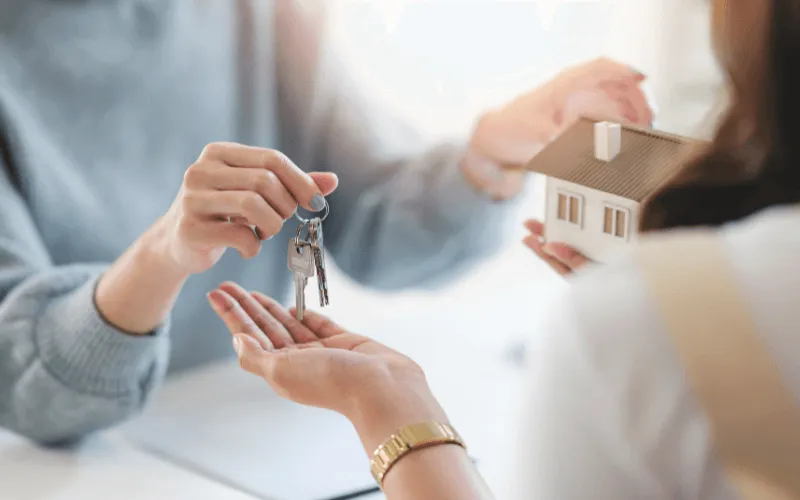 Estate agent handing over house keys during rental agreement in Spain