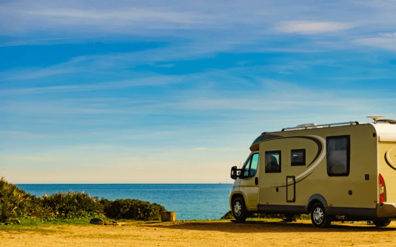 Motorhome parked by the sea on a scenic coastal route in Spain