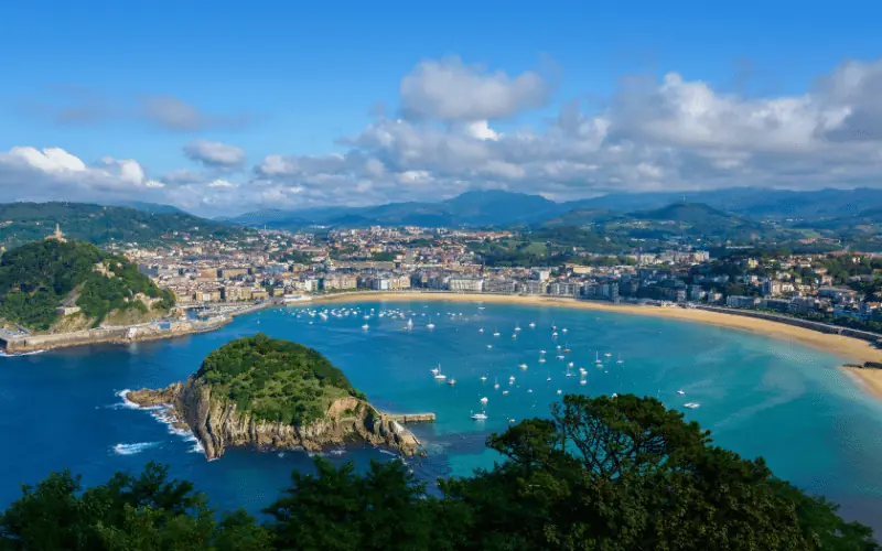 Scenic coastal view of San Sebastian bay in Spain under a blue sky