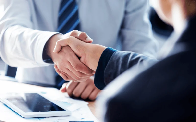 Business handshake representing Schengen visa approval for international work opportunities