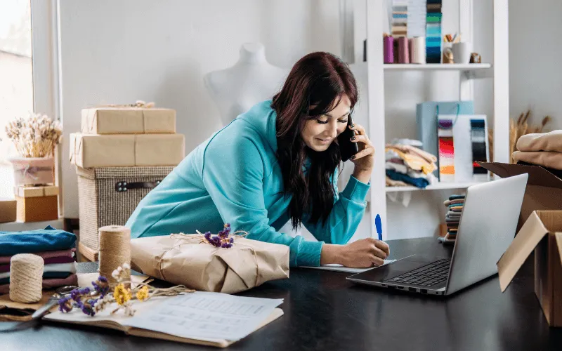 Young entrepreneur working from home packing orders for online business