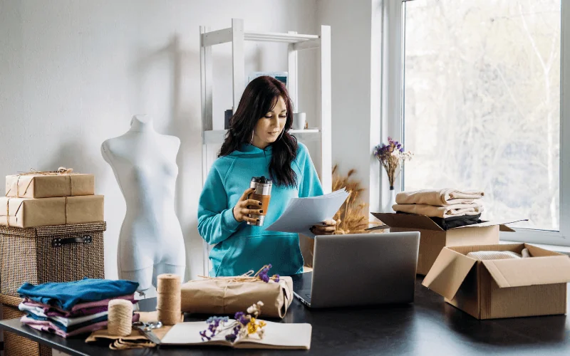 Self-employed woman managing utility bills in home office workspace