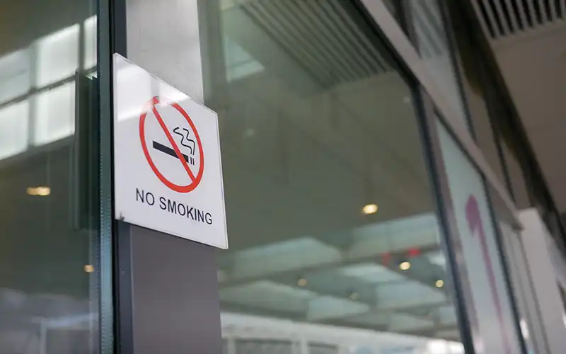 no smoking sign under new outdoor smoking and vaping ban