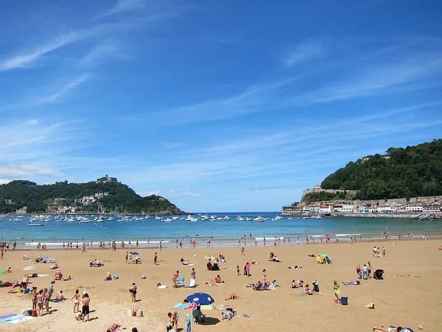 Tourists relaxing on a sunny beach in Spain with scenic coastal views