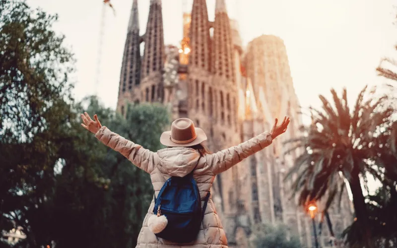 Tourist from USA celebrating in front of La Sagrada Familia in Barcelona