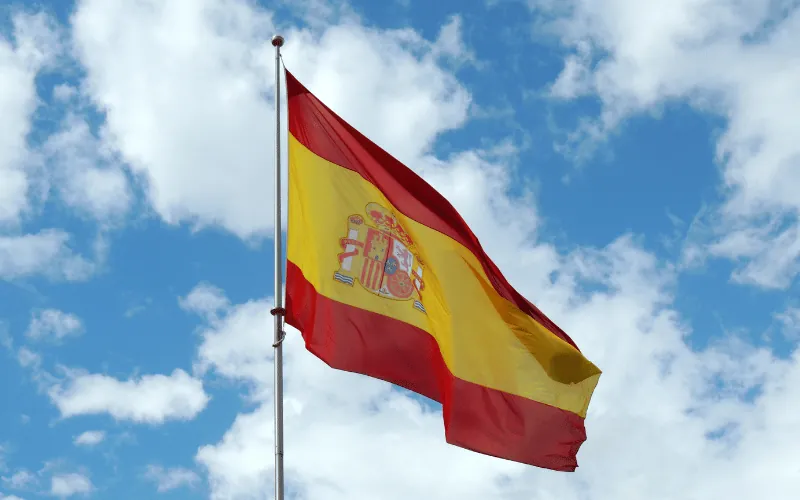 Spanish flag waving in the sky on a clear day