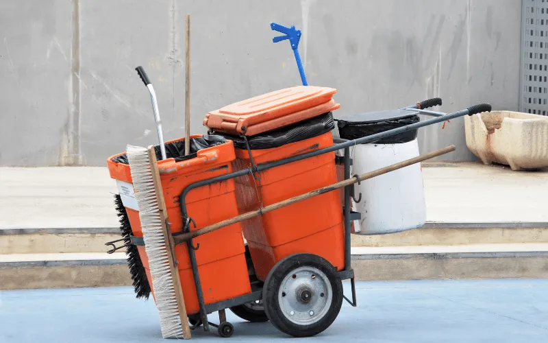 street cleaning cart with tools and bins in urban Spain