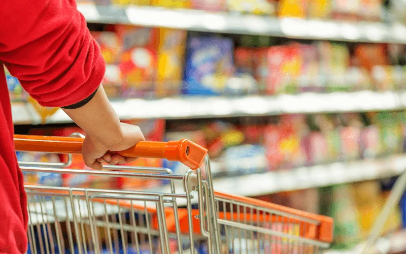 Supermarket shopper pushing trolley