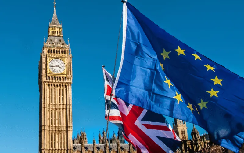 European Union and United Kingdom flags waving near Big Ben in London