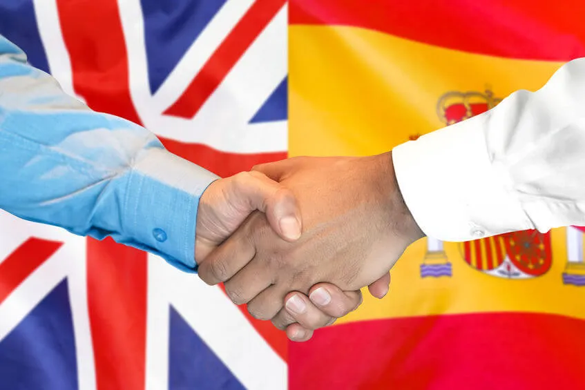 Handshake with British and Spanish flags
