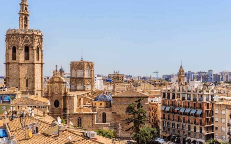 Cityscape of Valencia Spain showing historic buildings and cathedral under clear blue sky