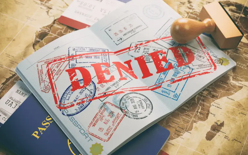 Passport with denied stamped in red across it