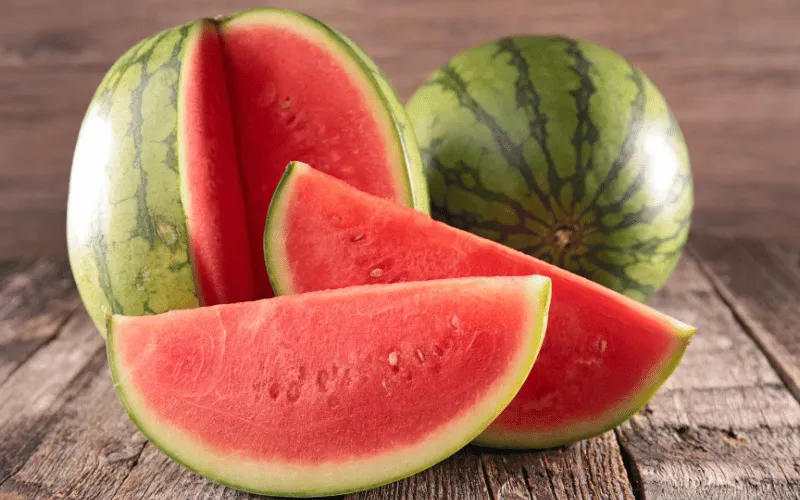 Fresh sliced watermelon on rustic wooden table in summer