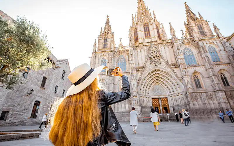 tourist taking photo of cathedral in barcelona