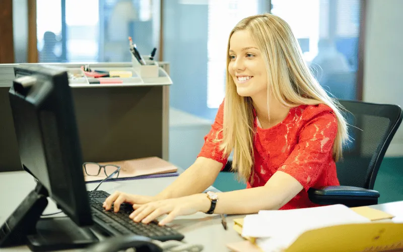 Young professional woman working at a computer in a modern office environment